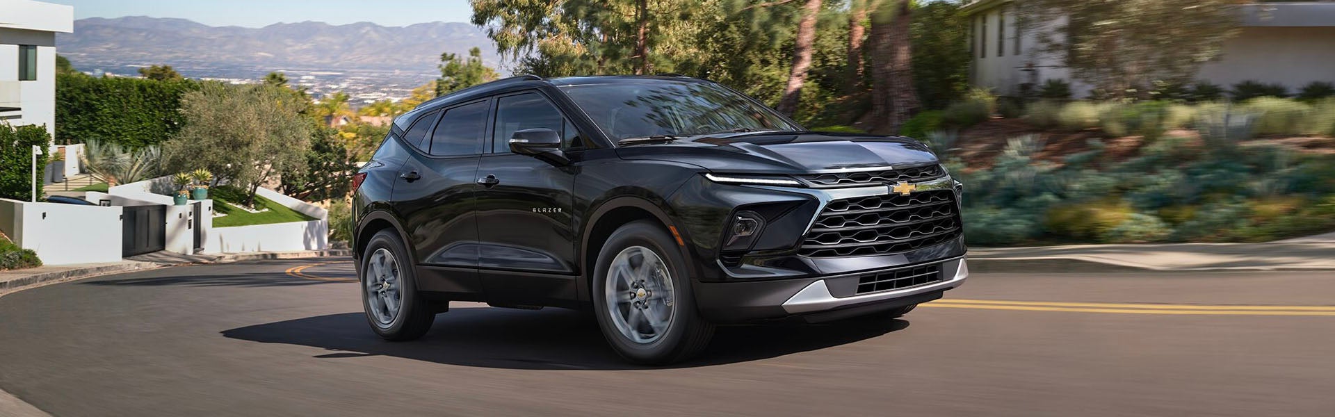 Chevrolet Blazer driving on a road, displaying its sleek, sporty profile in motion.