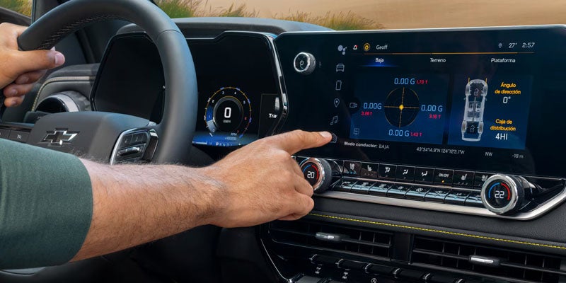 Driver tapping the touchscreen display in a Chevy Colorado.