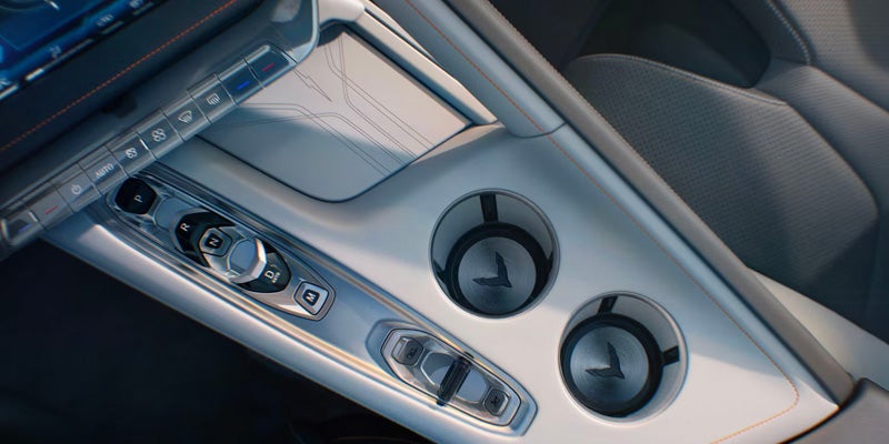 Close-up of a Corvette Z06's center console with two cup holders and gear controls.